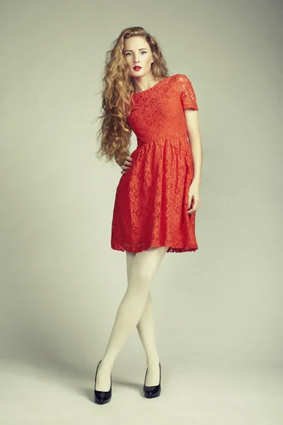 Fashion photo of young magnificent woman in red dress — Stock Photo, Image