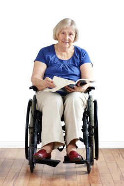 Senior disabled woman in wheelchair with book clipart