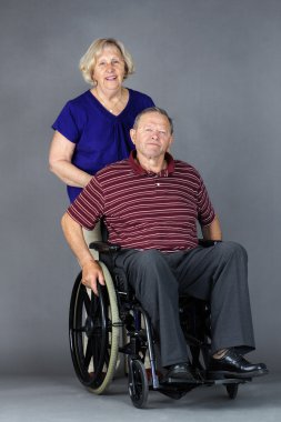 Senior couple with man in wheelchair clipart