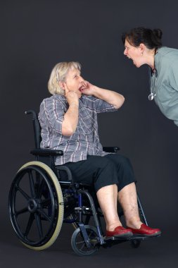 Elder abuse senior woman being shouted at by nurse clipart