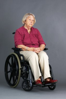 Sad senior woman in wheelchair clipart