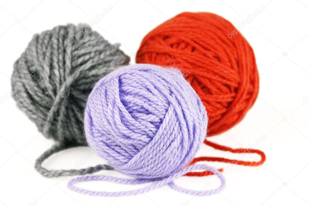 Balls of purple, orange and grey yarn or wool