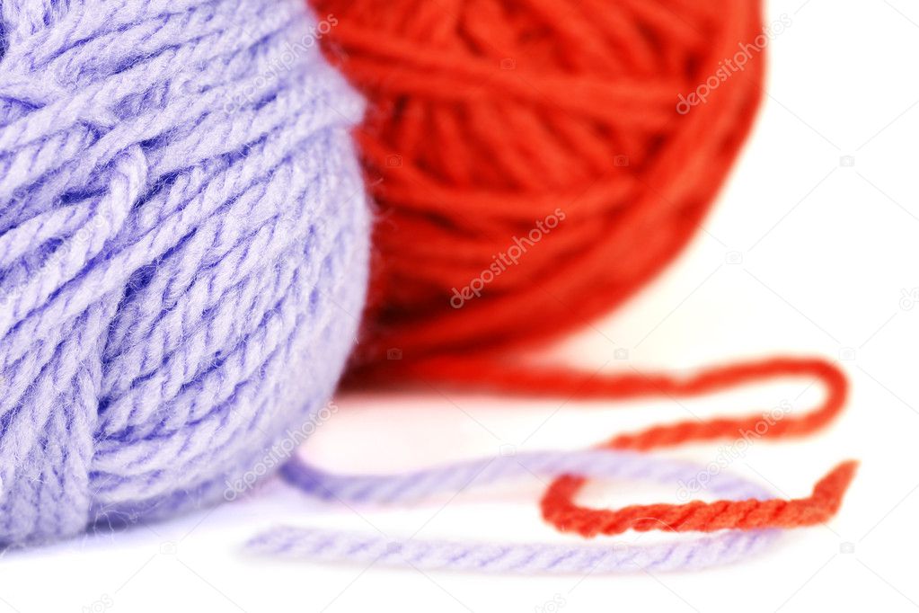 Balls of purple and orange yarn or wool