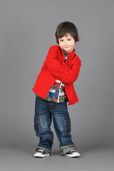 stock image Cute little boy in red with smirk