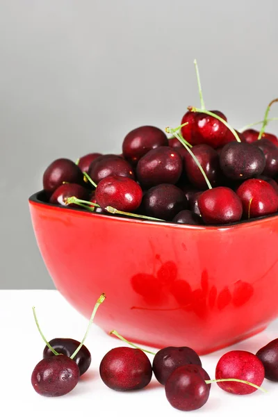 Red bowl of cherries — Stock Photo, Image