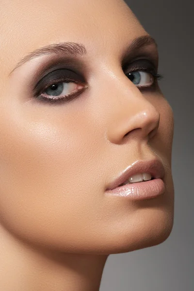 Closeup πορτρέτο ομορφιά του προσώπου ελκυστικό μοντέλο με visage μόδας. σκοτεινά και καπνιστή μάτι μακιγιάζ και μπεζ γυαλιστερό χείλη make-up — Φωτογραφία Αρχείου