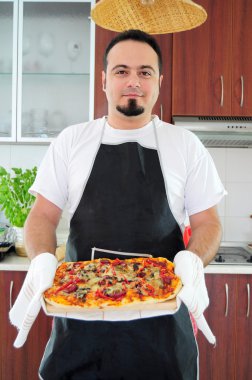 ev yapımı pizza ile mutfakta genç adam