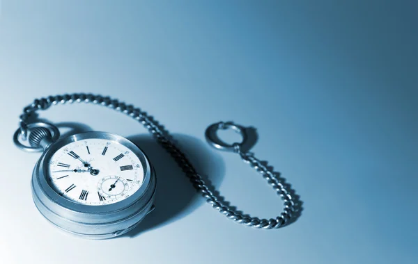 Old pocket watch with a chain, tinted blue — Stock Photo, Image