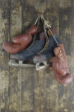 Old boxing gloves and hockey skates clipart