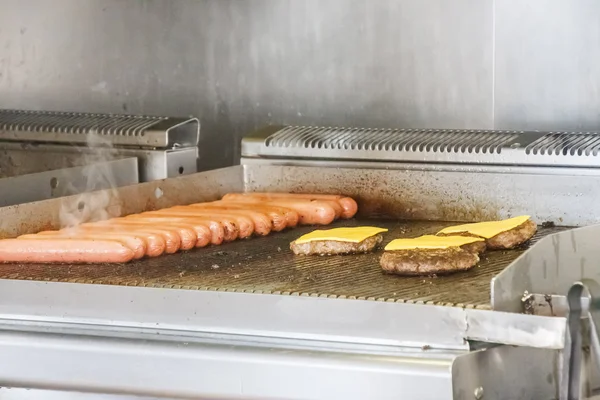 stock image Hot Dogs and Cheeseburgers on Grill