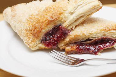 Fresh Raspberry Turnovers on a White Plate with Fork clipart