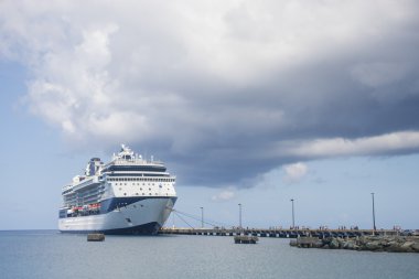 Passengers Leaving Cruise Ship Under Cloudy Skies