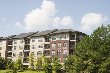 New Brick Apartments Under Nice Sky clipart