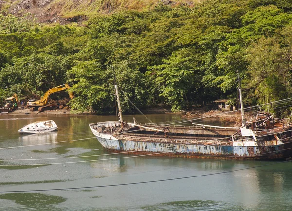 stock image Rusted Blue Ship Sinking by White Boat