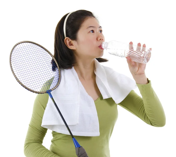 Drinking water after playing badminton — Stock Photo, Image