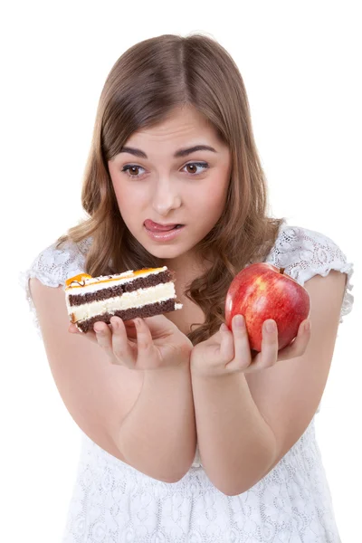 Girl with apple and cake in hands, closeup portrait — Stock Photo, Image