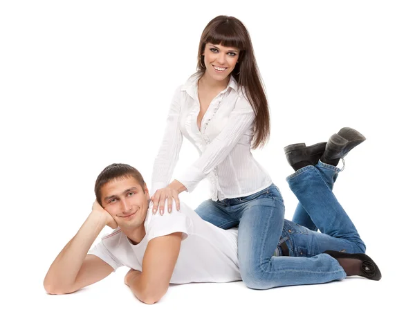Smiling couple in love lying on the floor — Stockfoto