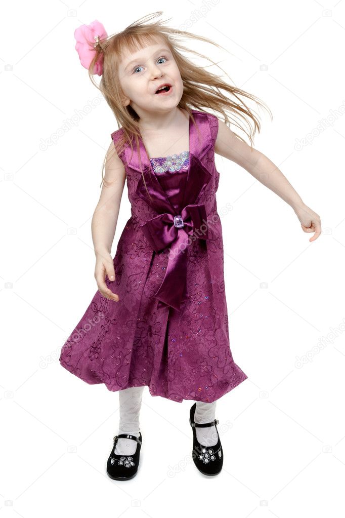 Full length of cheerful young girl jumping in joy over white bac
