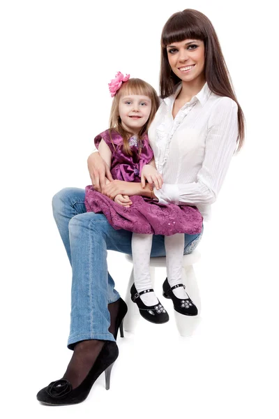 Mother with a cute daughter sitting on a chair — Stock Photo, Image
