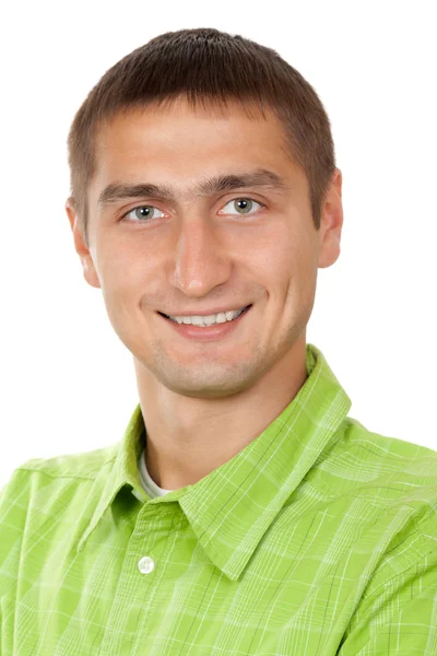 Porträt eines netten jungen Mannes in einem grünen Kleid im Studio auf weiß — Stockfoto