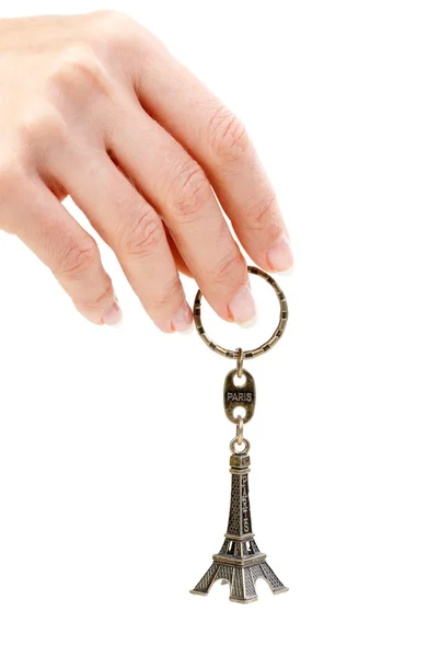 stock image Hand holding small Eiffel Tower statuette