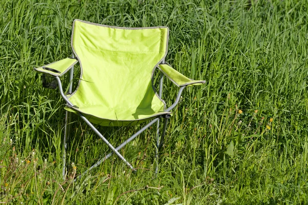 Sedia pieghevole verde sull'erba — Foto Stock