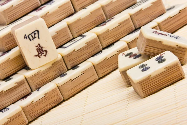 stock image Old chinese game mahjongg on bamboo mat background