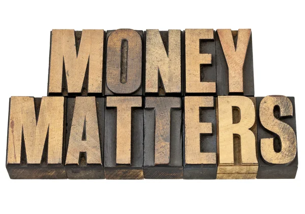 Money matters in wood type — Stock Photo, Image