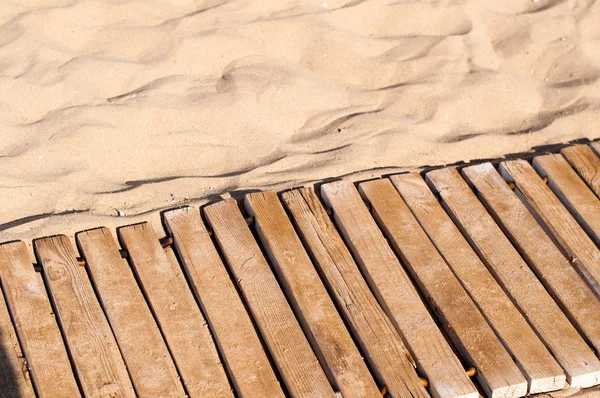 Paseo marítimo de madera envejecida en la arena —  Fotos de Stock
