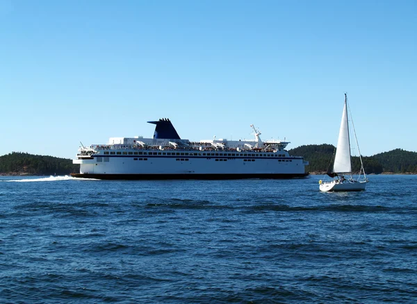 stock image Large Ferry and Sailboat Underway on Bay