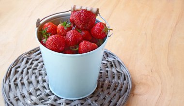 Berries of strawberry in a bucket