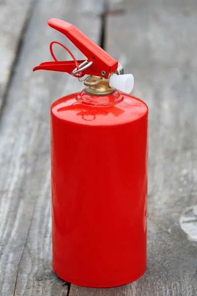 Extinguisher on the wooden sidewalk — Stock Photo, Image