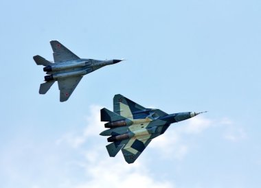 Fighters T-50 and MIG-29 in the sky clipart