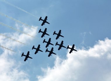 Aerobatic group on the background of white clouds clipart
