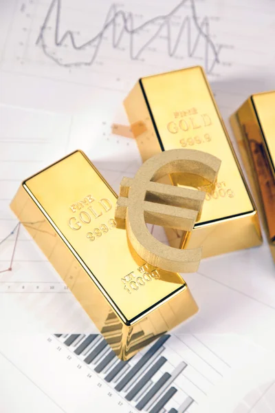 stock image Gold bars on graphs and statistics