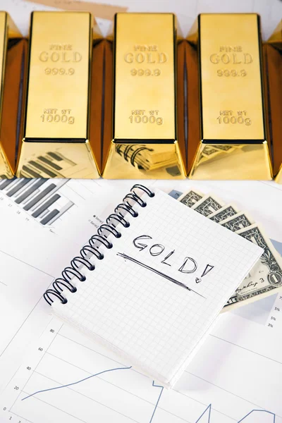 stock image Gold bars on graphs and statistics