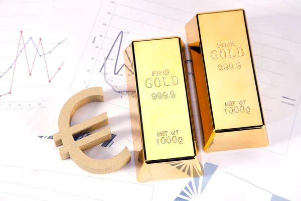 stock image Gold bars on graphs and statistics