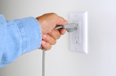 Closeup Man With Plug and Outlet clipart