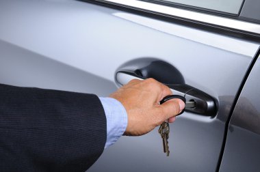 Man Putting Car Key into Door Lock clipart