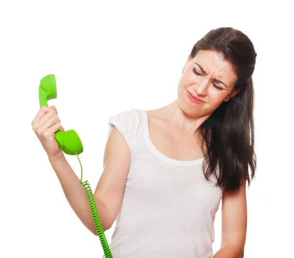 Young female getting stressed by someone on the phone. — Stock Photo, Image