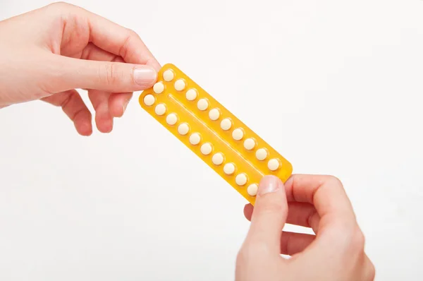 Woman holding birth control pills Royalty Free Stock Photos