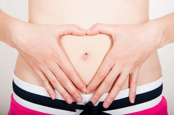 Young adult checking her belly fat Stock Photo