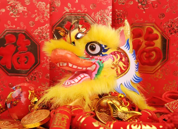 Chinesische Neujahrsornamente - traditioneller tanzender Drache, goldene Münze und rotes Geldbündel, roter Feuerwerkskörper — Stockfoto