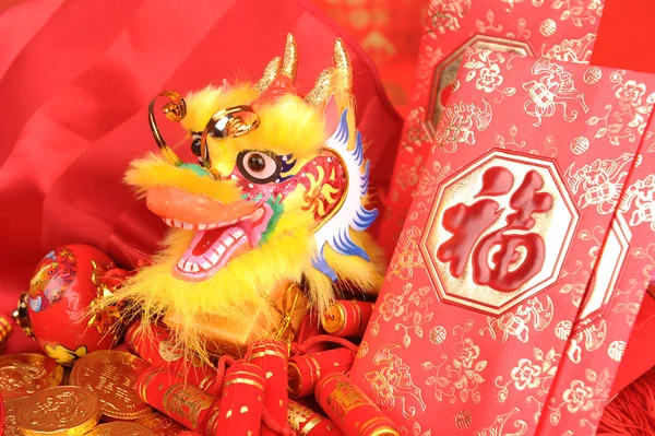Китайские новогодние украшения - традиционный танцевальный дракон, золотая монета и красный пакет денег, красный фейерверк — стоковое фото