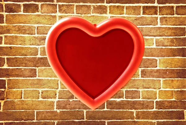 Red photo frame on old brick wall — Stock Photo, Image