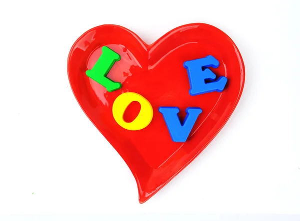 Hechizo de amor con bloques de alfabeto en la placa de forma de corazón — Foto de Stock