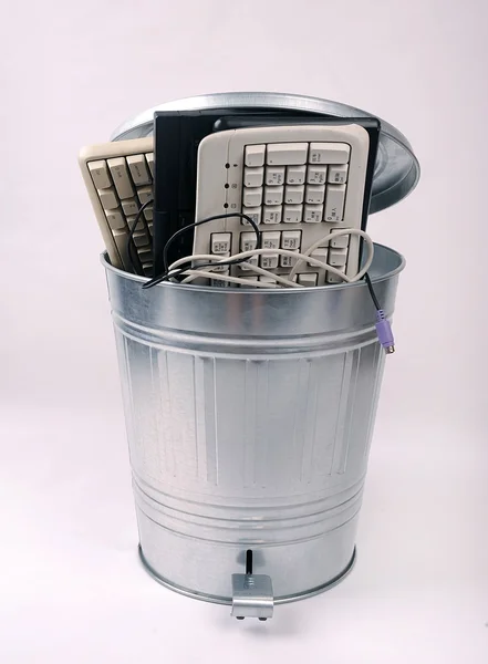 stock image Different computer parts and phone in trash can