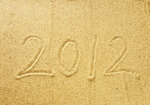 2012 mensaje de año nuevo en la playa de arena —  Fotos de Stock