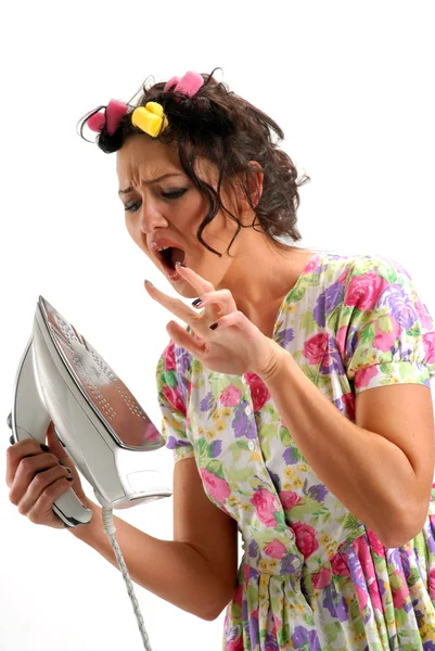 stock image The girl in hair curlers with an iron