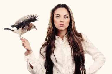 Portrait of beautiful girl in fashion style with bird on the hand clipart